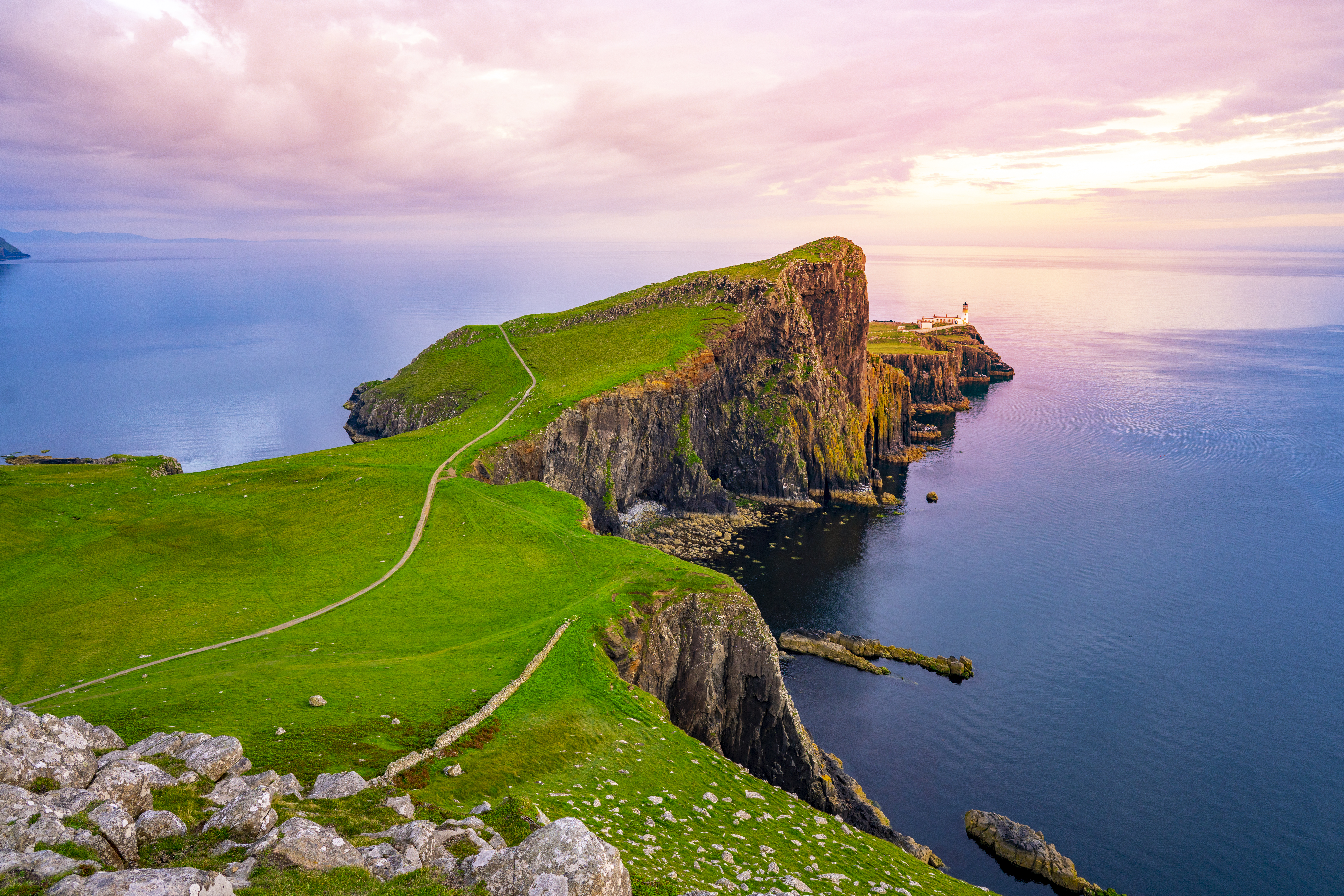 Rugged, green cliffs overlooking the ocean on the Scottish coastline